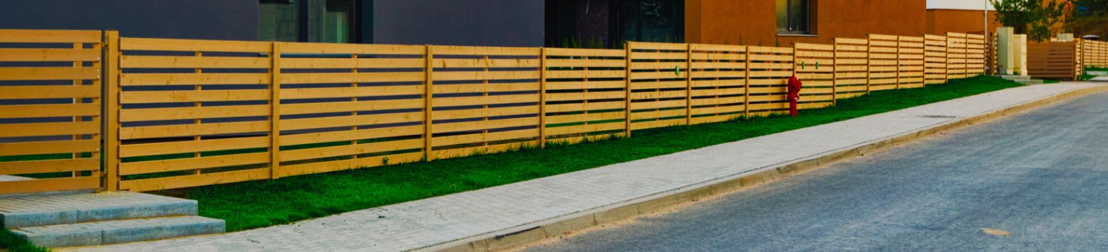 A view to a residential community with a wooden fence